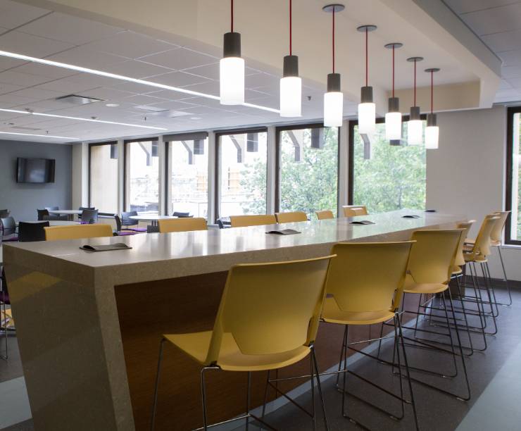 Student space includes chairs, tables and a bar with high chairs.