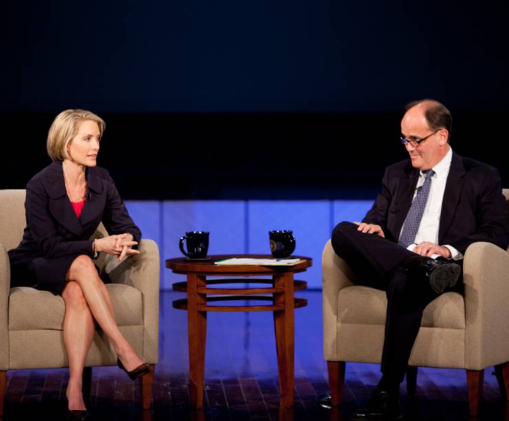 Dana Perino sits on stage speaking to Larry Parnell.
