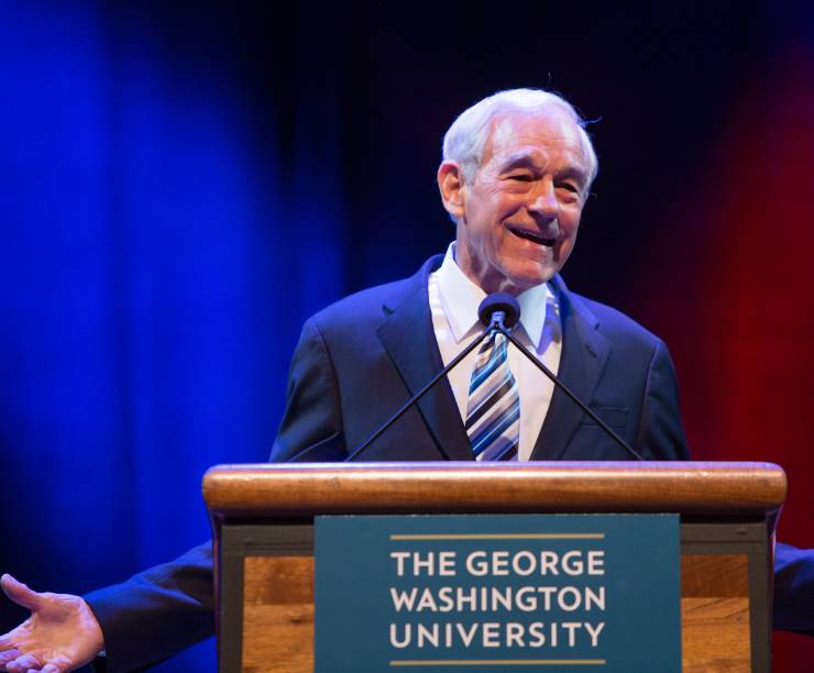 Ron Paul speaks at a podium onstage.