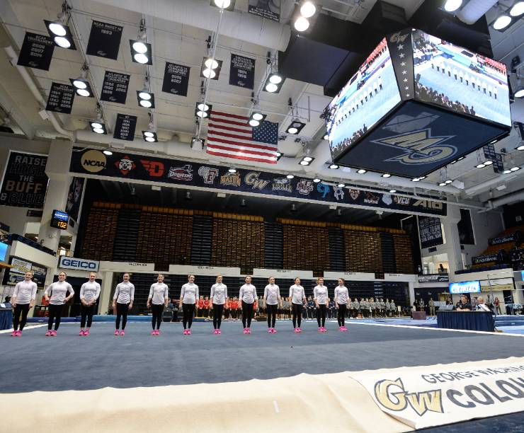 Gymnasts compete in vault, uneven bars, balance beam and floor exercise in the Smith Center arena.