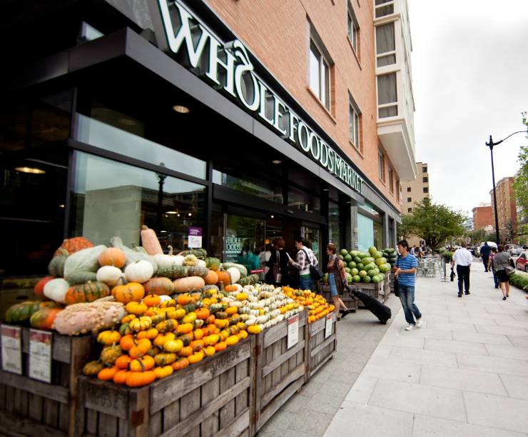 Whole Foods store front with a display of pumpkins.
