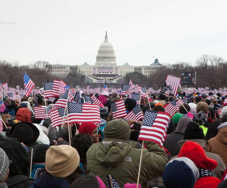 A crowd waves flags in front of the Capitol during the Inauguration.