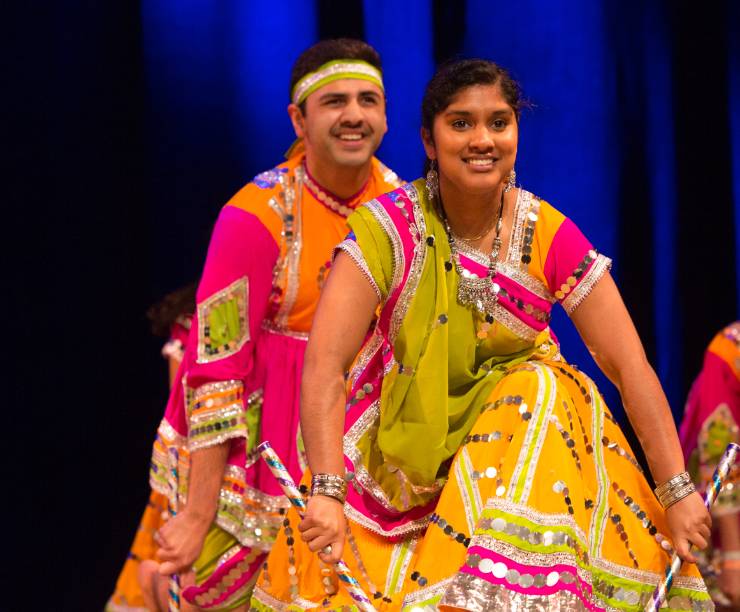 Dancers in brightly colored costumes perform an Indian dance.