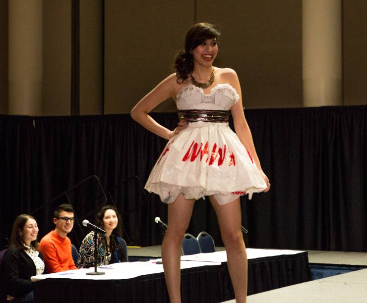 A model in a recycled-material dress walks the runway.