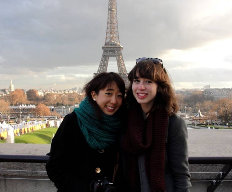 Two students pose in front of the Eiffel Tower.