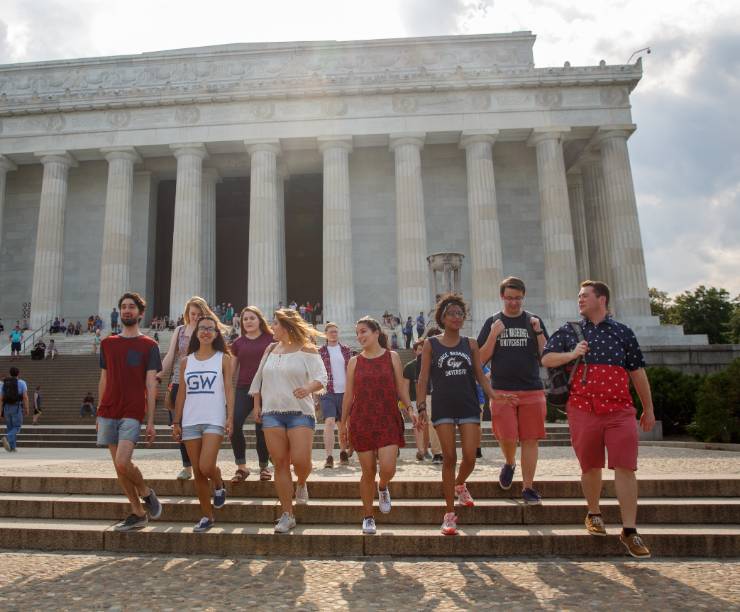 GW students walking off the steps of the Lincoln Memorial on the National Mall.