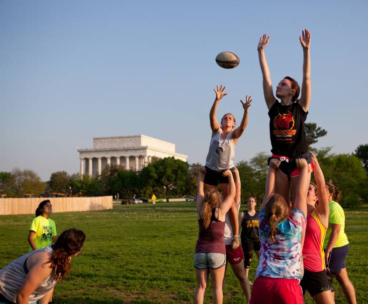 Students play rugby on the National Mall.