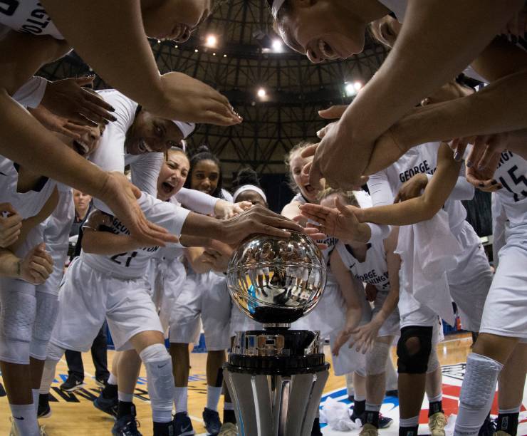 Women's basketball team celebrating a win.