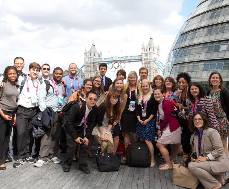 A group of students pose for a photo in front of the Tower bridge in London.