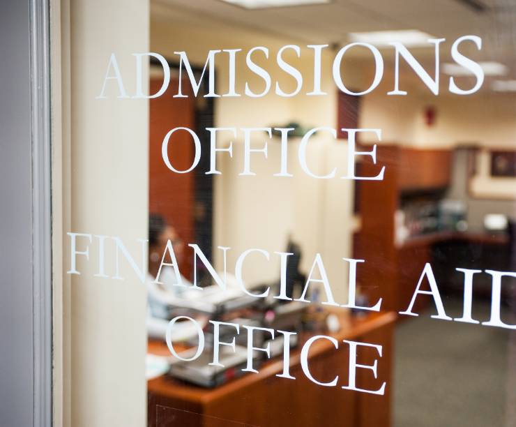 Glass doors to GW Law's Office of Admissions and Financial Aid which have 