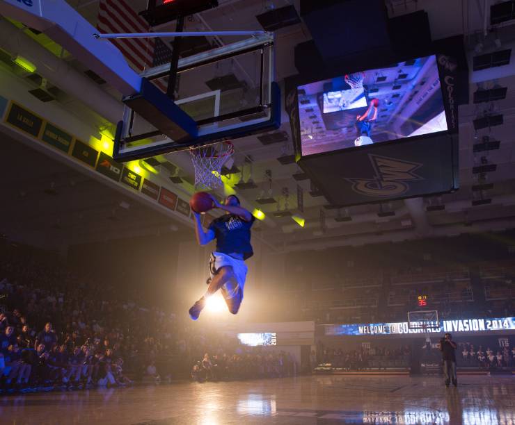 A basketball player jumps for a slam dunk.