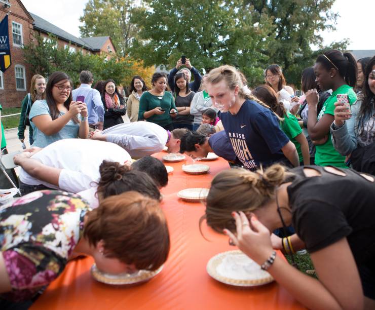 Students compete in a pie eating contest.