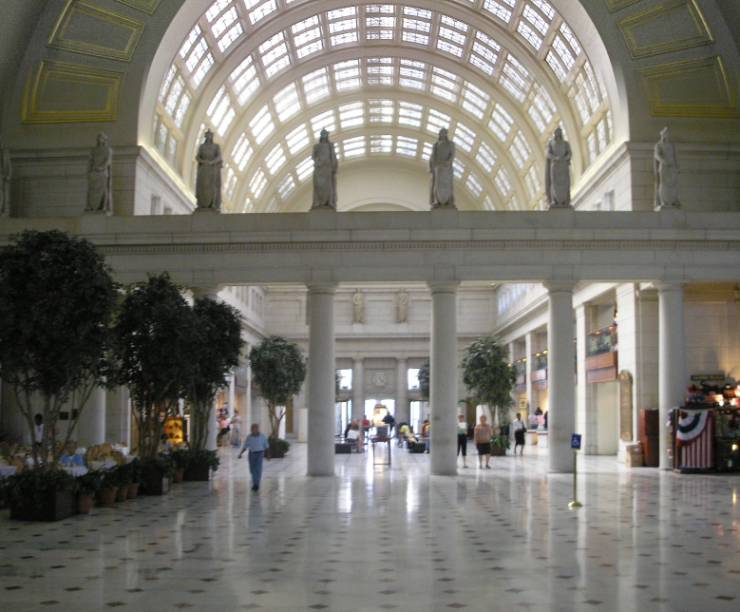 Interior shot of union station showing marble floors, columns, statues and a windowed dome.