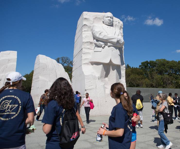 GW students walk in front of the Martin Luther King, Jr. memorial.