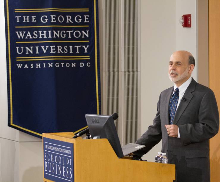 Ben Bernanke lectures at a GW classroom podium.