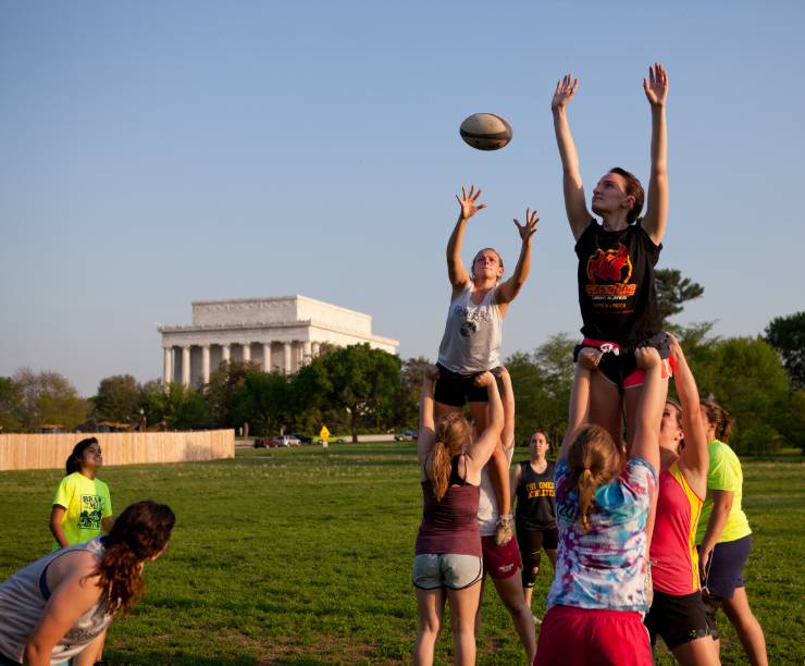 Students play rugby on the National Mall.