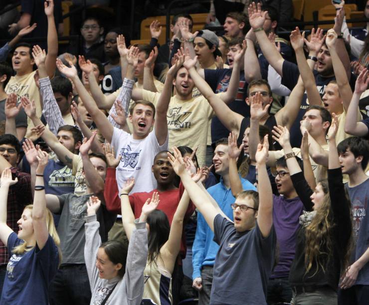 Members of the GW George's Army cheer on the GW Men's Basketball Team.