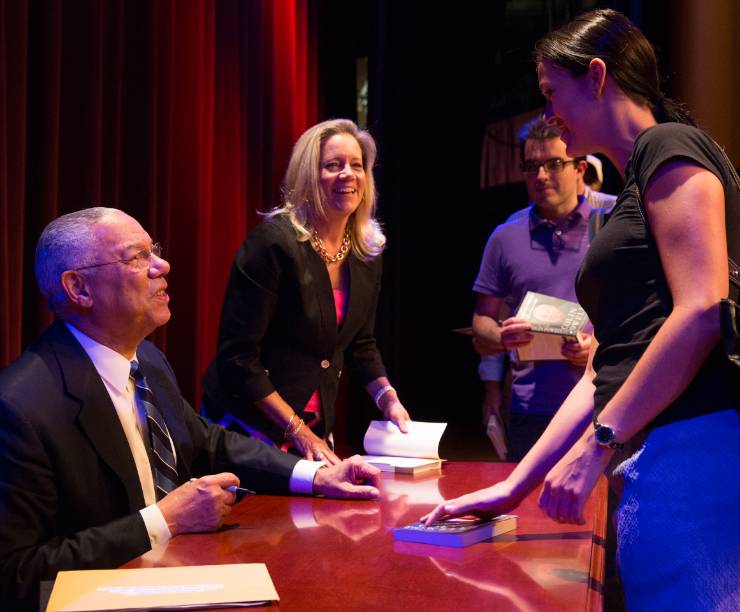 A student greets Colin Powell at Lisner Auditorium.