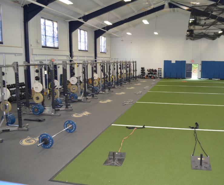 A view of an weights and indoor running and training space.