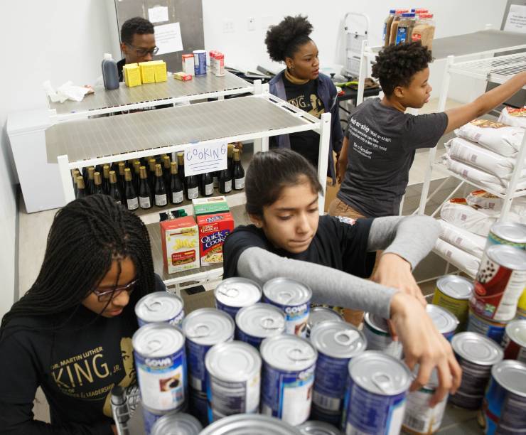 Members of the GW community stock the shelves of The Store in District House, which provides food to students in need, on MLK Day of Service and Leadership.