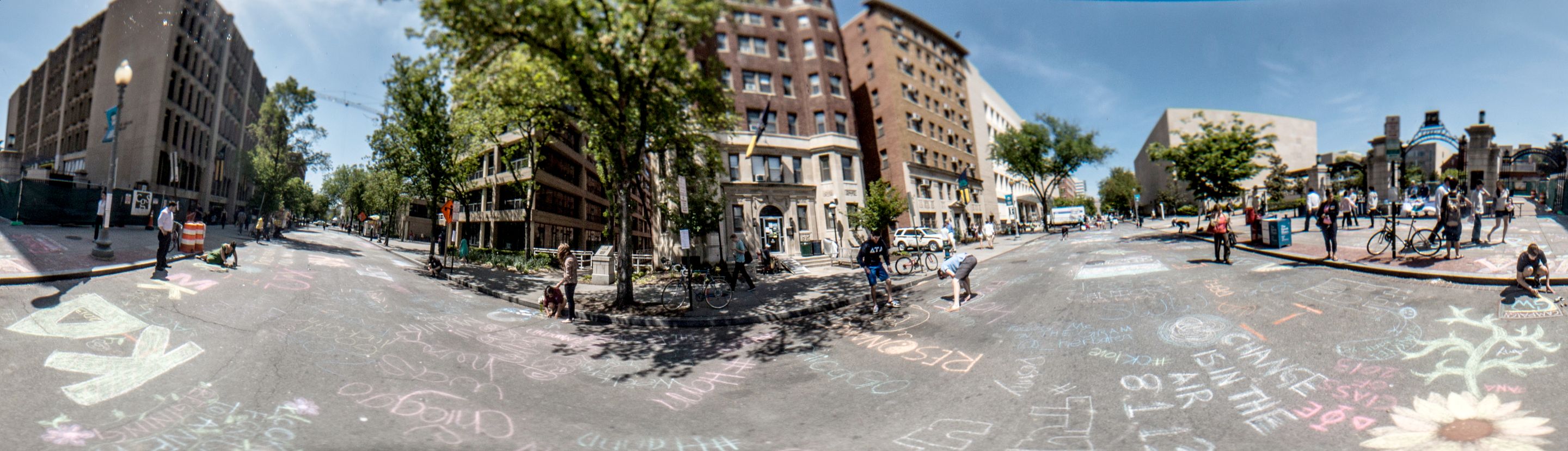 A panoramic view of H Street with chalk drawings on the road.