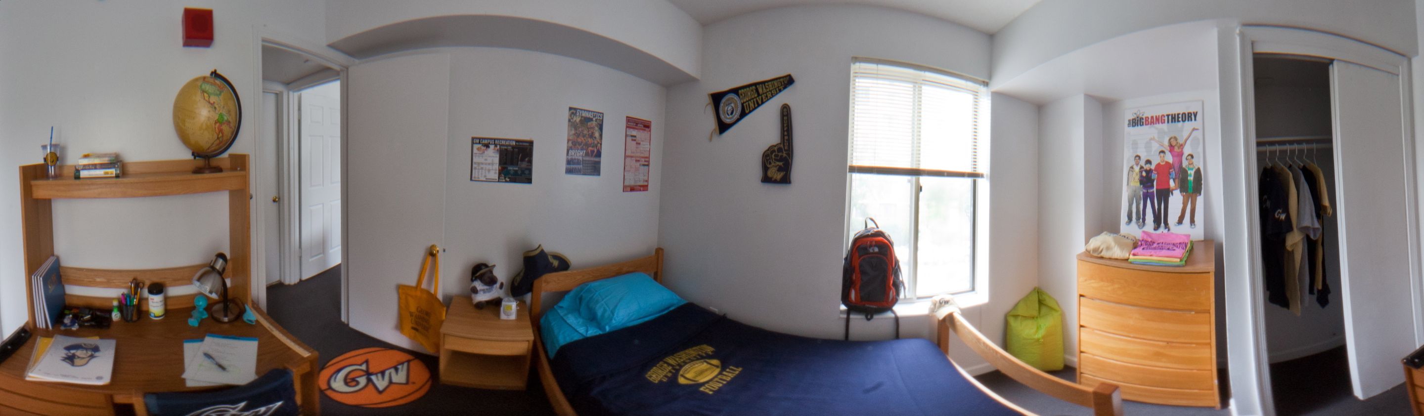 A panoramic view of a single residence hall room.