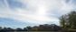 A panoramic view of the Athletic Field and a blue, sunny sky.