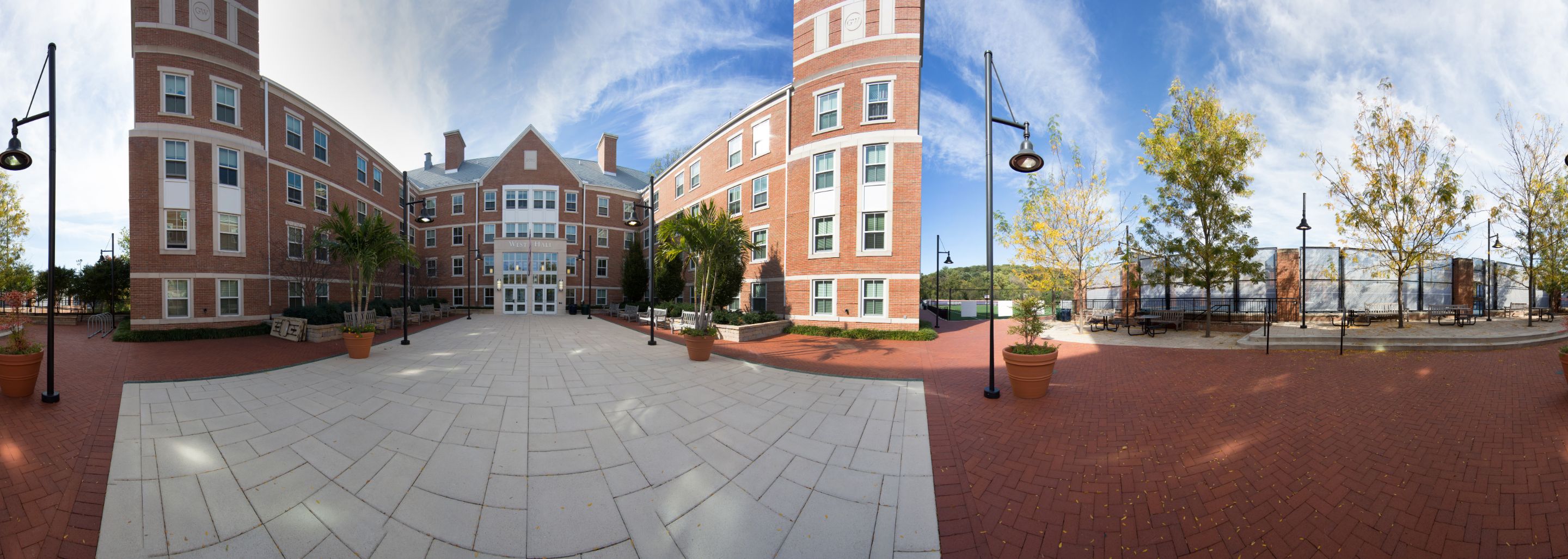 Panoramic view of West Hall exterior and adjacent tennis courts.