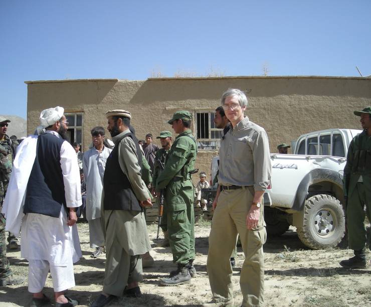 Stephen Biddle in Afghanistan with a selection of people around him.