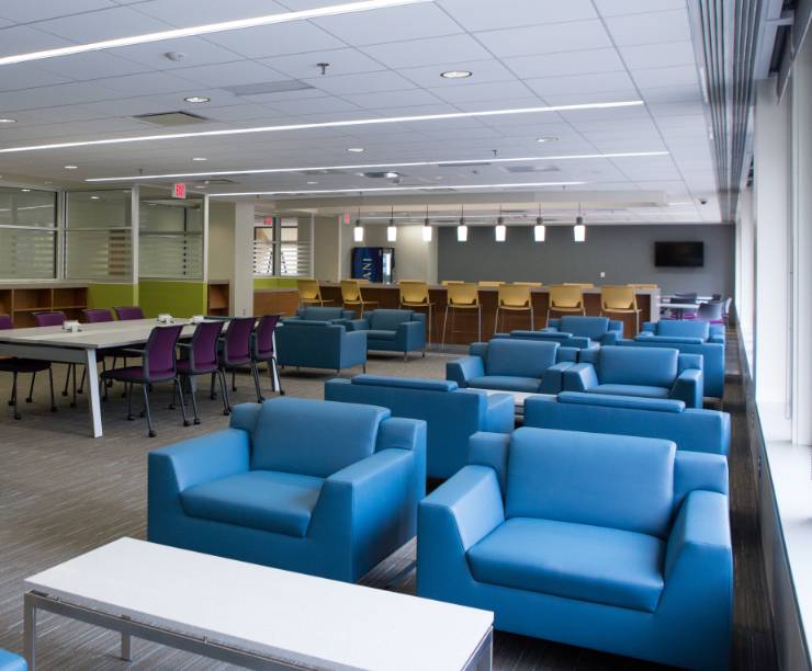 Comfortable chairs and coffee tables fill the lounge area.