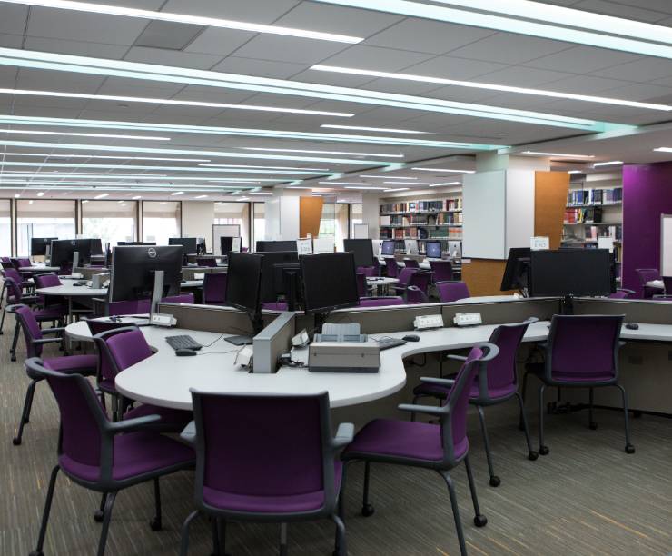 A cluster of computer stations on the library floor.